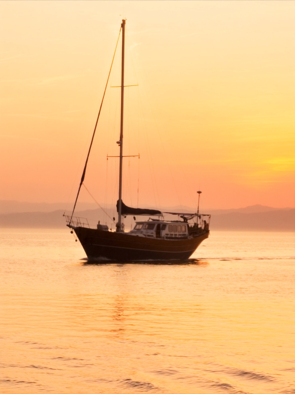 Sailboat at golden sunset on Banderas Bay